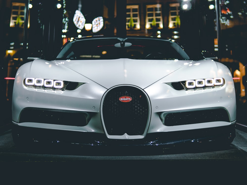 Silver hypercar front end lit at night