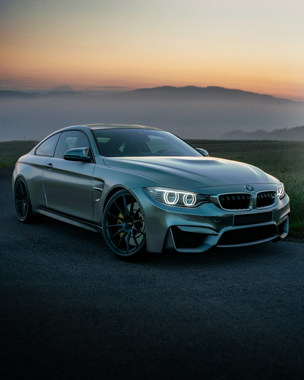 Coupe at dusk with fog behind